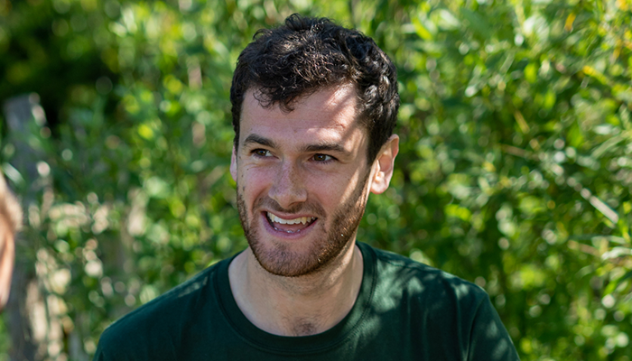 The communications officer of Avon Wildlife Trust, George Cook wearing a green shirt and smiling.