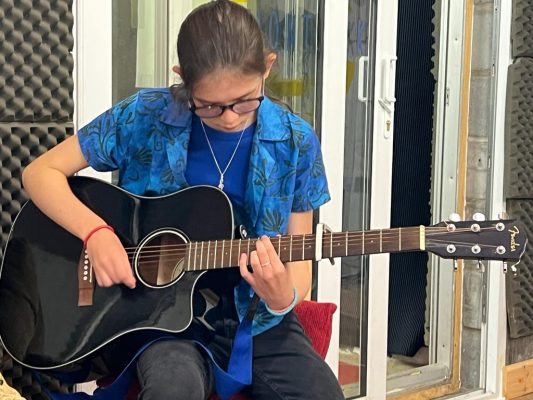 Young person playing guitar