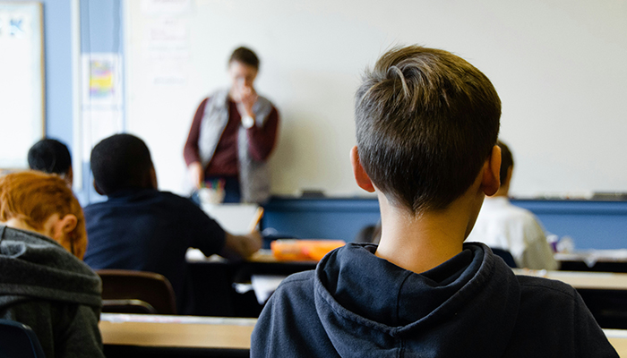 The back of a child's head in a school room
