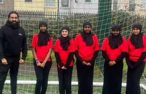 Girls wearing their specially-adapted hijabs on a football pitch.
